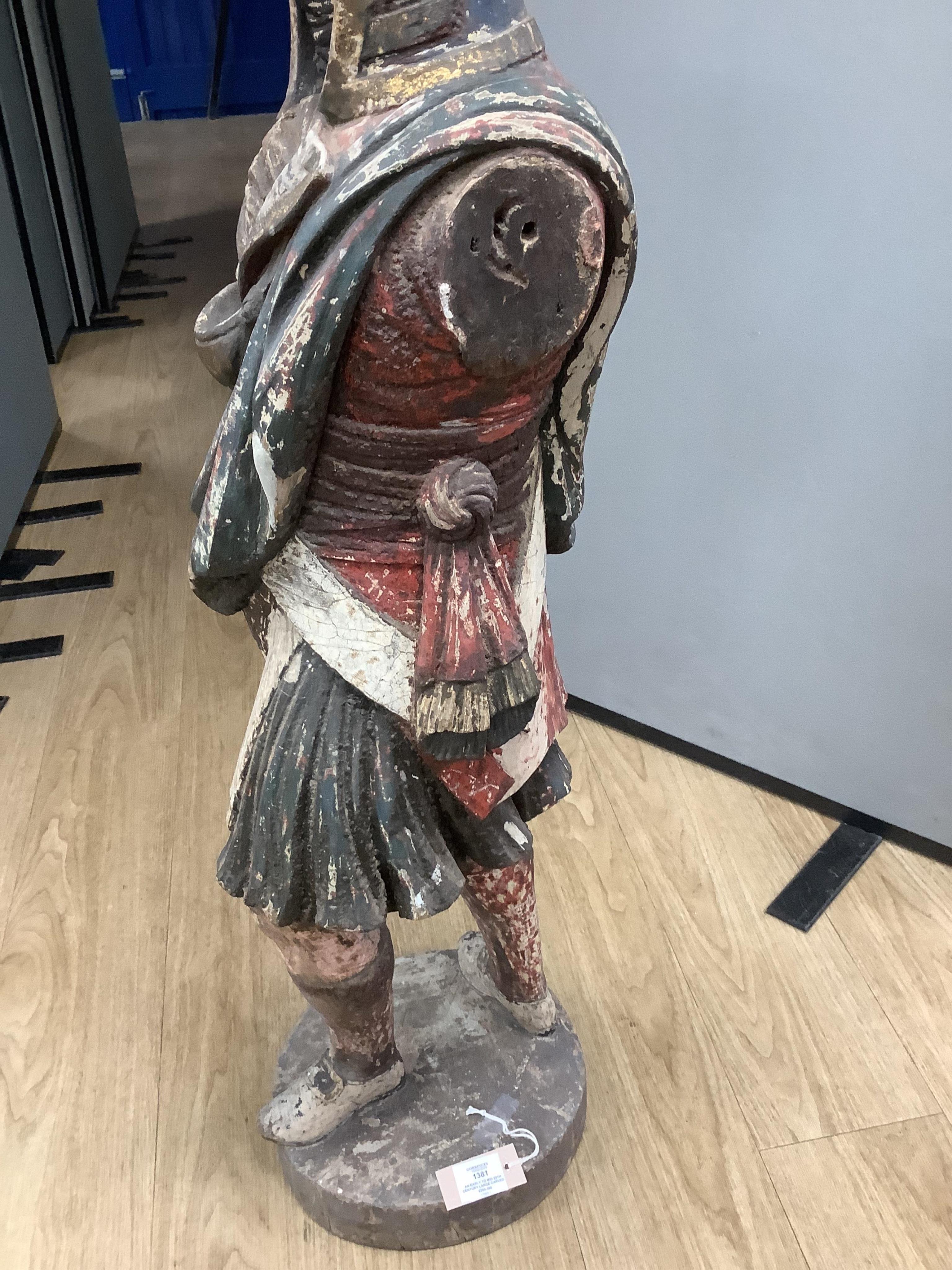 A large 19th century carved and painted Highlander ‘Snuff’ shop advertising figure. 109cm high. Condition - paint work and base weathered, arms detached.